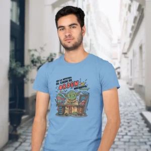 Camiseta de hombre con la imagen de Yoda sentado en un escritorio desordenado y el texto "En la oficina el caos es, orden necesito"